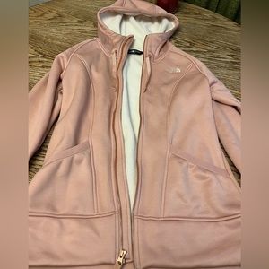 Women’s pink fleece lined The North Face zip up hoodie.